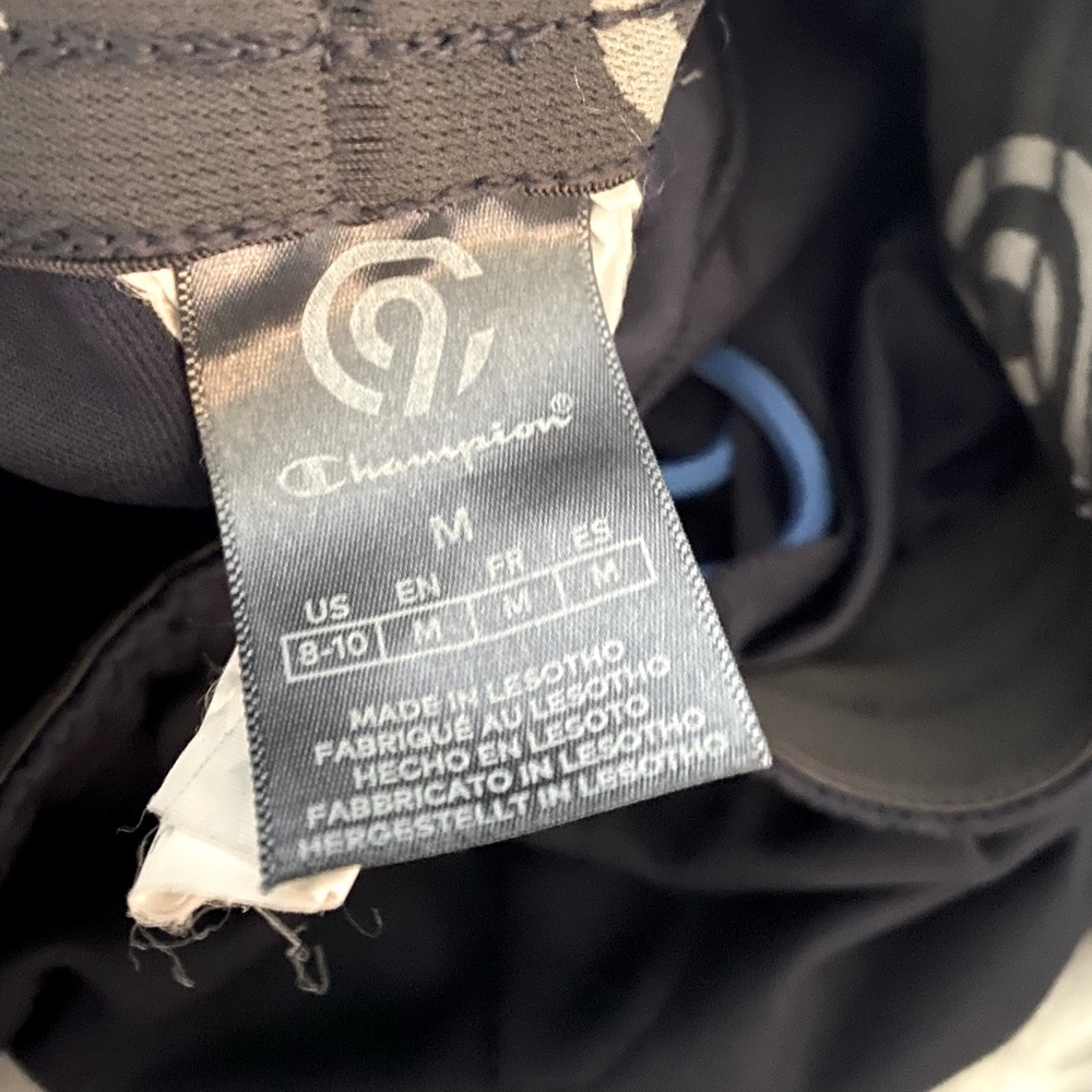 Kids M Champion sweat pants. Navy blue with light blue zip pocket.